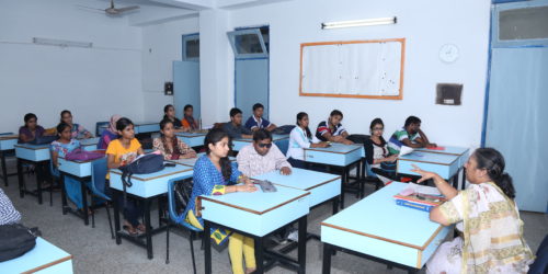 A classroom with students and staff in Durgabai Deshmukh College of Special Education