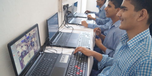 The students of JPM working on laptops in the computer lab of the school