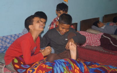 Boys laugh as they have a good time in the hostel