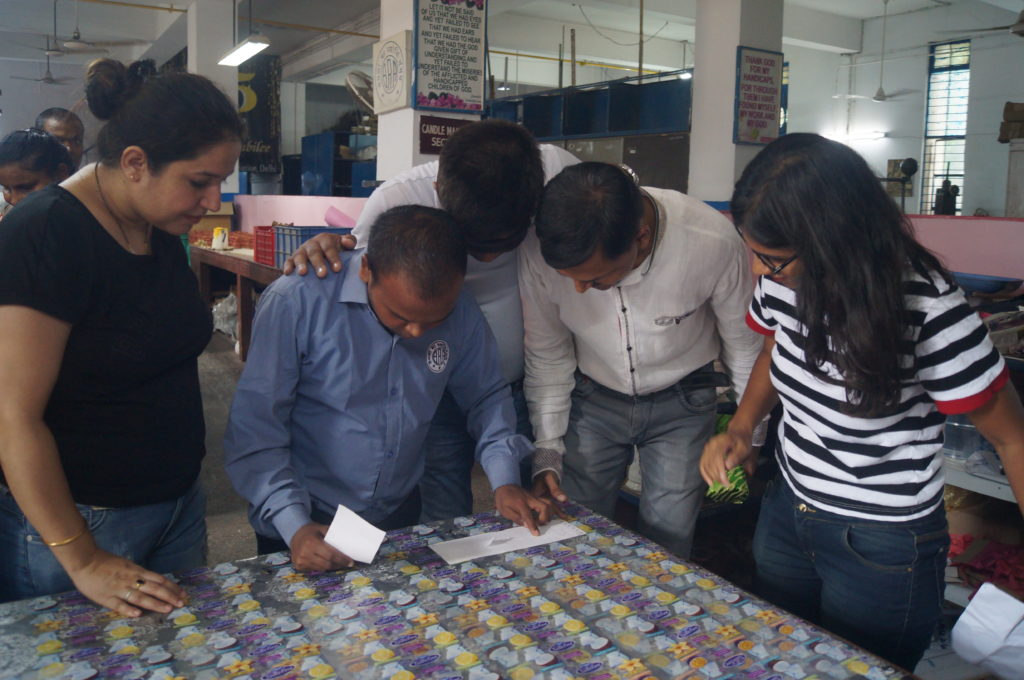 A trainee reading clues in Braille in the game of treasure hunt